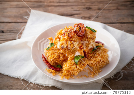 Thai dessert, Mixed Crispy Rice Noodle (Mee Krob) in white plate on wood background Thai dessert, Mixed Crispy Rice Noodle (Mee Krob) in white plate on wood background 79775313