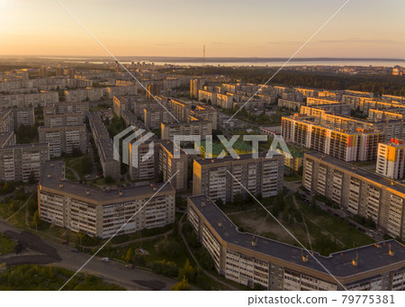 Many identical roofs of identical buildings in city area at sunset, aerial view Many identical roofs of identical buildings in city area at sunset, aerial view 79775381