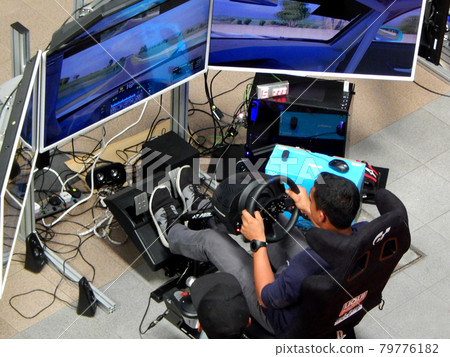 SEREMBAN, MALAYSIA -MAY 20, 2017: Simulation race car video player game with four big screens and cockpit controls like a racing car. 79776182