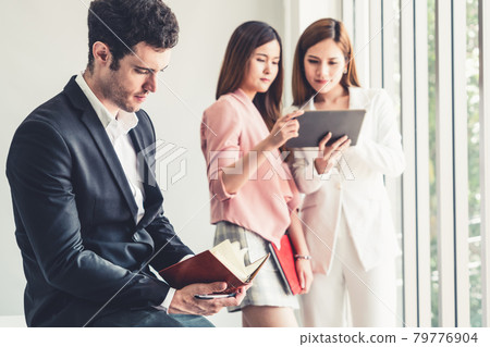 Businessman reading book in business office . Businessman reading book in business office . 79776904