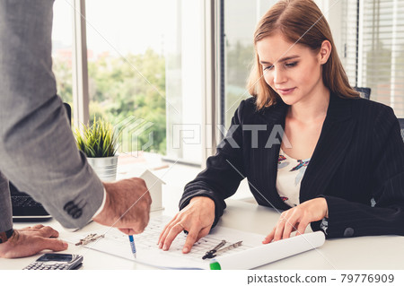 Architect and engineer working with drawing. Architect and engineer working with drawing. 79776909