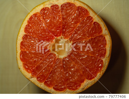 Close-up of a red grapefruit cut in half. Close-up of a red grapefruit cut in half. 79777406