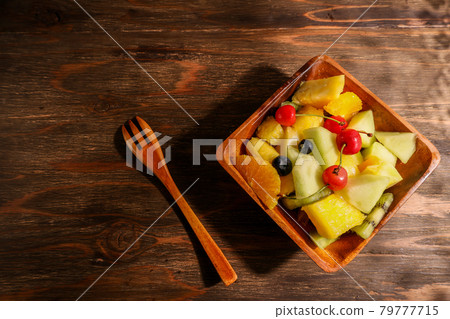 Fruit salad on wooden tableware Fruit salad on wooden tableware 79777715