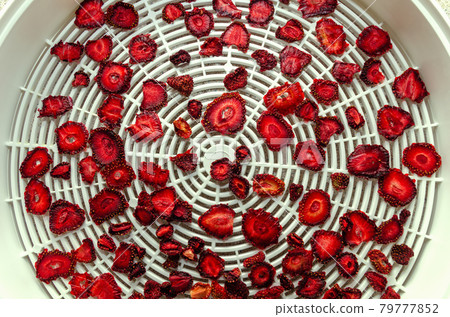 Sliced Strawberry Cooking Homemade Strawberry Chips in Vegetable Dryer. 79777852