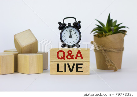 Q and A, questions and answers live symbol. Concept words 'Q and A live' on wooden blocks on a beautiful white background. Black alarm clock and house plant. Business and Q and A live concept. Q and A, questions and answers live symbol. Concept words 'Q and A live' on wooden blocks on a beautiful white background. Black alarm clock and house plant. Business and Q and A live concept. 79778353
