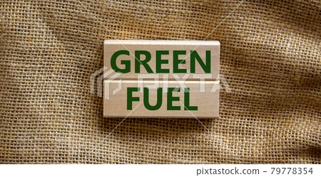 Green fuel symbol. Wooden blocks form the words 'green fuel' on beautiful canvas background. Business and green fuel concept. Copy space. Green fuel symbol. Wooden blocks form the words 'green fuel' on beautiful canvas background. Business and green fuel concept. Copy space. 79778354
