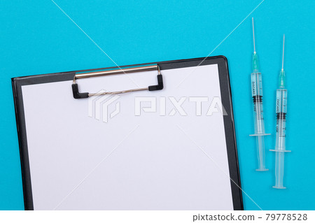 Vaccination or Revaccination Concept - Two Medical Syringe on Blue Table 79778528