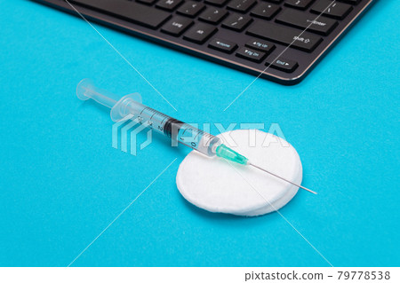 Vaccination or Revaccination Concept - A Medical Syringe on Blue Table 79778538