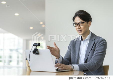Video call online conference image of a businessman in his thirties talking to a webcam Video call online conference image of a businessman in his thirties talking to a webcam 79782587