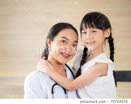 Portrait of a female doctor and a young female patient smiling brightly before being admitted to the hospital. 79784976