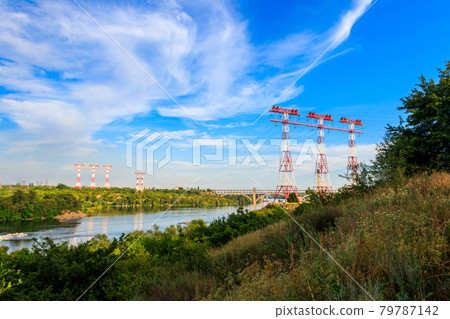 High voltage power line across the Dnieper river on Khortytsia island in Zaporizhia, Ukraine High voltage power line across the Dnieper river on Khortytsia island in Zaporizhia, Ukraine 79787142