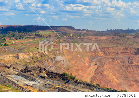 Huge iron ore quarry with working dump trucks and excavators in Kryvyi Rih, Ukraine 79787501
