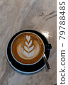 Latte art coffee in black cup on marble table 79788485