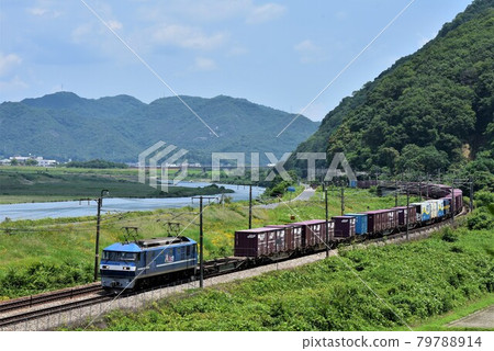A long freight train that runs fast on Sanyo Road against the backdrop of the Yoshii River, a large river in Okayama Prefecture. A long freight train that runs fast on Sanyo Road against the backdrop of the Yoshii River, a large river in Okayama Prefecture. 79788914