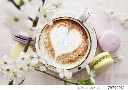 Coffee with a heart-shaped pattern and sweet macaroons desserts Coffee with a heart-shaped pattern and sweet macaroons desserts 79790081