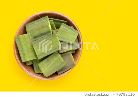 Fruit of Broken Bone tree in wooden bowl on yellow background. 79792130