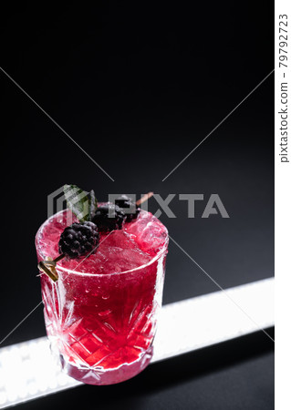 closeup of alcohol blueberry special cocktail with blackberry in wineglass 79792723