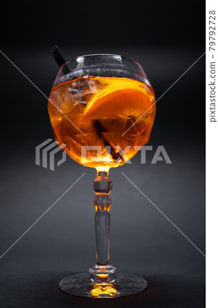 aperol spritz cocktail drink with orange and ice in glass on black background 79792728