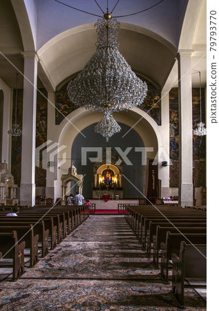 Hall for parishioners, altar with the icon of the Virgin, crystal chandeliers from under the vaulted ceilings in the Cathedral of St. Sarkis in Tehran Hall for parishioners, altar with the icon of the Virgin, crystal chandeliers from under the vaulted ceilings in the Cathedral of St. Sarkis in Tehran 79793770