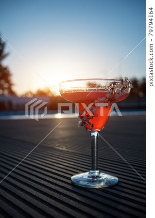 hemingway daiquiri cocktail drink with grapefruit in glass outdoor at sunset hemingway daiquiri cocktail drink with grapefruit in glass outdoor at sunset 79794164