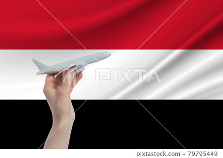 Airplane in hand with national flag of Yemen Travel to Yemen 79795449