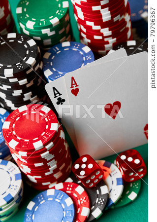 Casino chips, playing cards and dices on green fabric table Casino chips, playing cards and dices on green fabric table 79796367