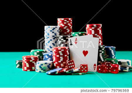 Casino chips, playing cards and dices on green fabric table Casino chips, playing cards and dices on green fabric table 79796369