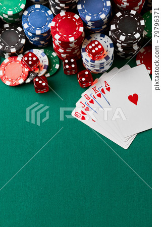 Casino chips, playing cards and dices on green fabric table Casino chips, playing cards and dices on green fabric table 79796371