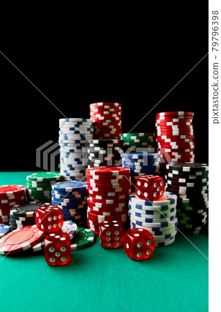 Pile of Casino pocker gambling chips and dices on green table 79796398