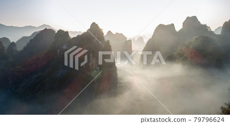 Aerial of beautiful sunrise over foggy  karst mountain peak landscape 79796624