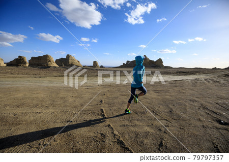 Fitness woman trail runner cross country running  on sand desert 79797357