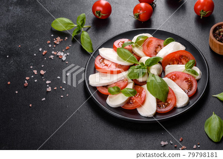 Italian caprese salad with sliced tomatoes, mozzarella cheese, basil, olive oil Italian caprese salad with sliced tomatoes, mozzarella cheese, basil, olive oil 79798181