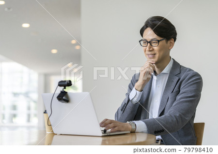 Video call online conference image of a businessman in his thirties talking to a webcam 79798410
