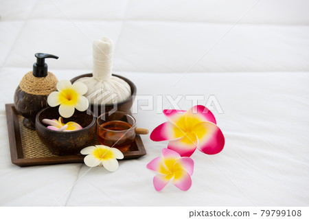 Set of spa treatments, natural oil, and plumeria flowers Set of spa treatments, natural oil, and plumeria flowers 79799108