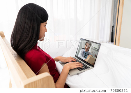 Asian doctor or therapist help relieve stress and provide knowledge and understanding about Insomnia to patients video conference call online live talk remotely at home in Bedroom Asian doctor or therapist help relieve stress and provide knowledge and understanding about Insomnia to patients video conference call online live talk remotely at home in Bedroom 79800251