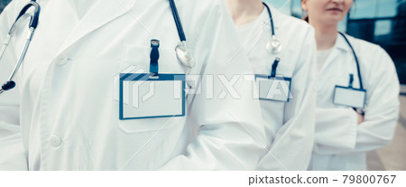 group of medical specialists with blank badges standing in a row. close up. 79800767