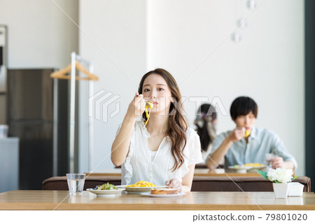 A woman eating pasta at a cafe A woman eating pasta at a cafe 79801020