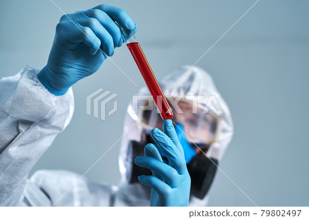 tube with the test results in the hands of a virologist scientist. 79802497