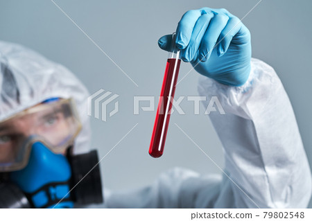 tube with the test results in the hands of a virologist scientist. 79802548