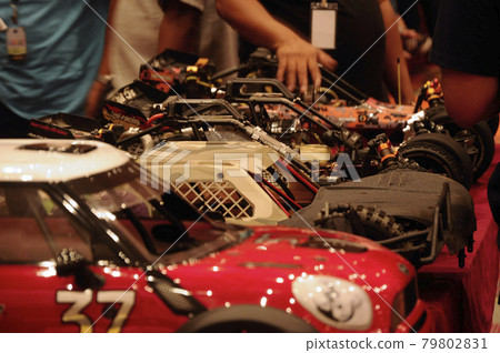 SERDANG, MALAYSIA -JULY 30, 2016: Custom remote control cars and its component on the display on the red desk.  SERDANG, MALAYSIA -JULY 30, 2016: Custom remote control cars and its component on the display on the red desk.  79802831