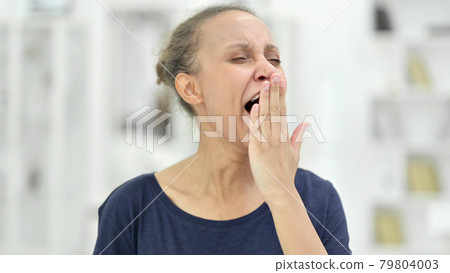 Portrait of Sleepy Young African Woman Yawning  79804003