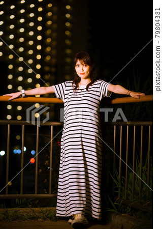 Girls taking a walk in the park at night, avoiding hot hours 79804381