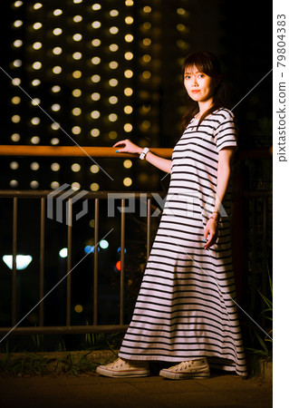 Girls taking a walk in the park at night, avoiding hot hours Girls taking a walk in the park at night, avoiding hot hours 79804383