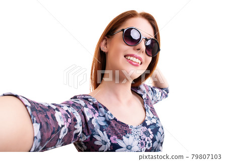Smiling young girl with sunglasses taking a selfie Smiling young girl with sunglasses taking a selfie 79807103