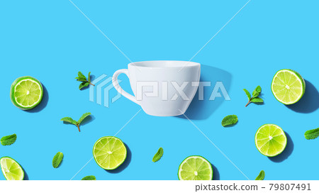 Fresh limes with tea cup overhead view 79807491