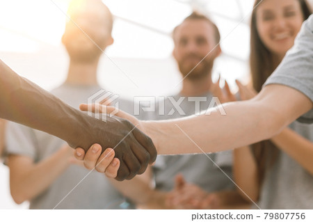 close up. handshake of two students on the background of the st close up. handshake of two students on the background of the st 79807756