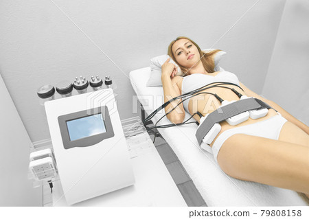 Laser lipo equipment. Cosmetic fat reduce treatment. Woman in medicine salon. Laser lipo equipment. Cosmetic fat reduce treatment. Woman in medicine salon. 79808158