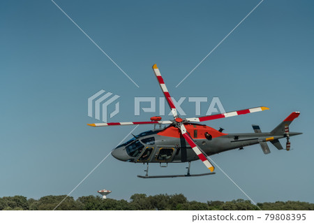 A helicopter for rescue and transportation operations, military production, flies in the sky over the forest. 79808395