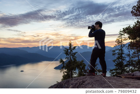 Adventure Photographer Hiking and taking pictures of Canadian mountain landscape 79809432