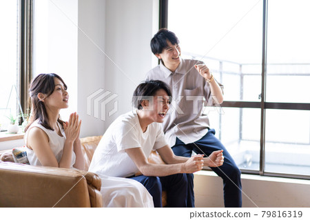 Young men and women who get excited by watching sports 79816319